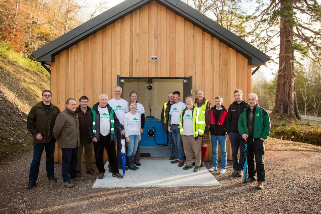 Community members outside BroomPower community hydro