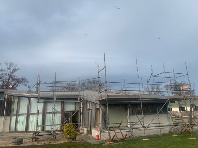 solar panels being installed on the roof of Ardross Community Hall