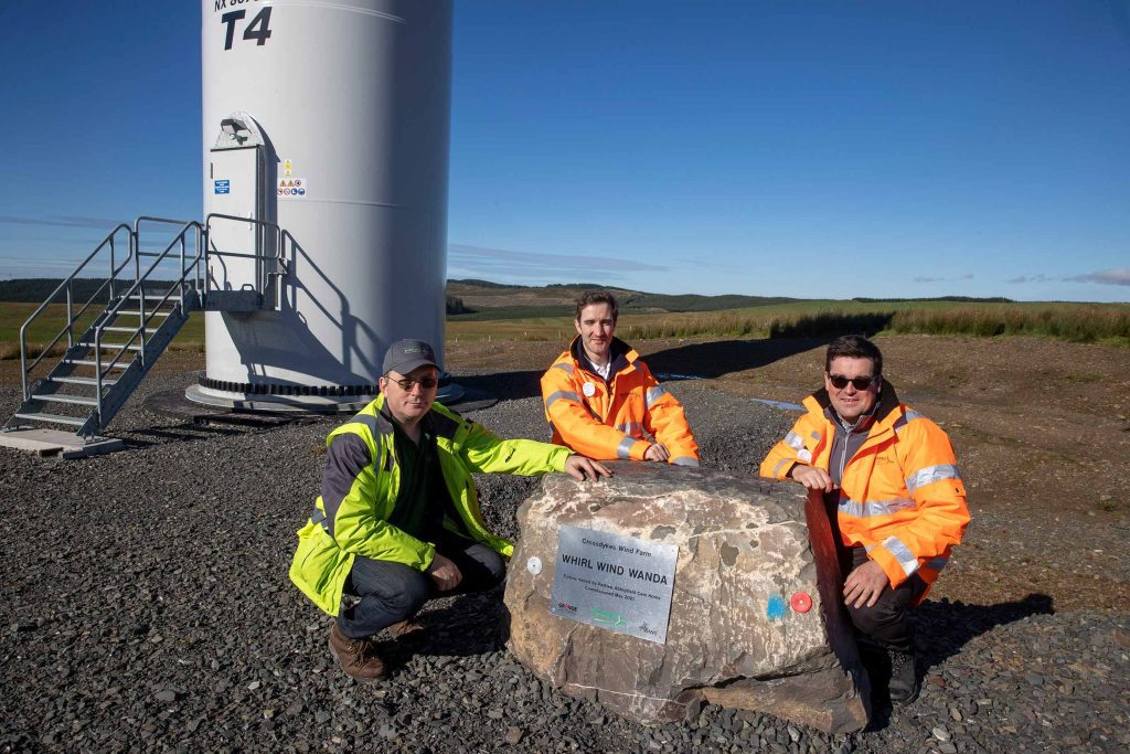 Workers unveil a plaque at Crossdykes wind farm